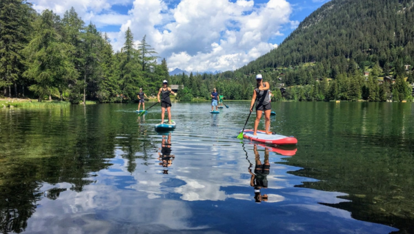 Stand up paddle boarding on mountain lake in Switzerland Stand up paddle boarding on mountain lake in Switzerland