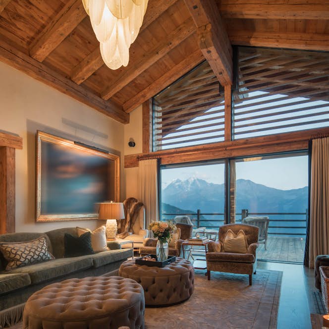 accommodation - The Alpine Estate - chalet norte open living room at golden hour with view and fireplace